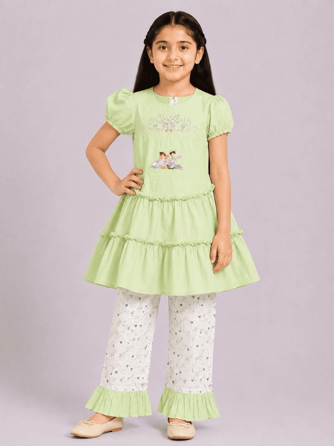 Girls pastel green tiered lawn top with puff sleeves and white printed flared trousers